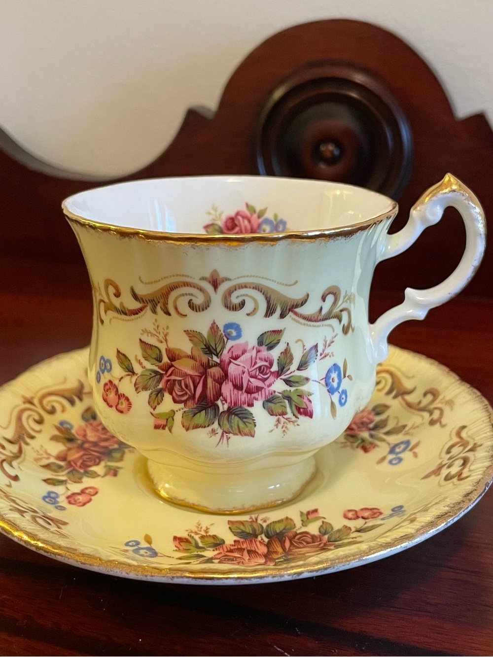 PARAGON Yellow Tea Cup and Saucer with Pink Rose and Blue Floral Motif